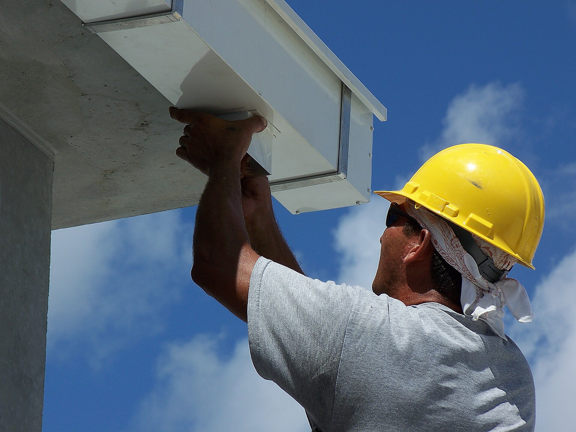 Professional installing a box gutter at the roofline