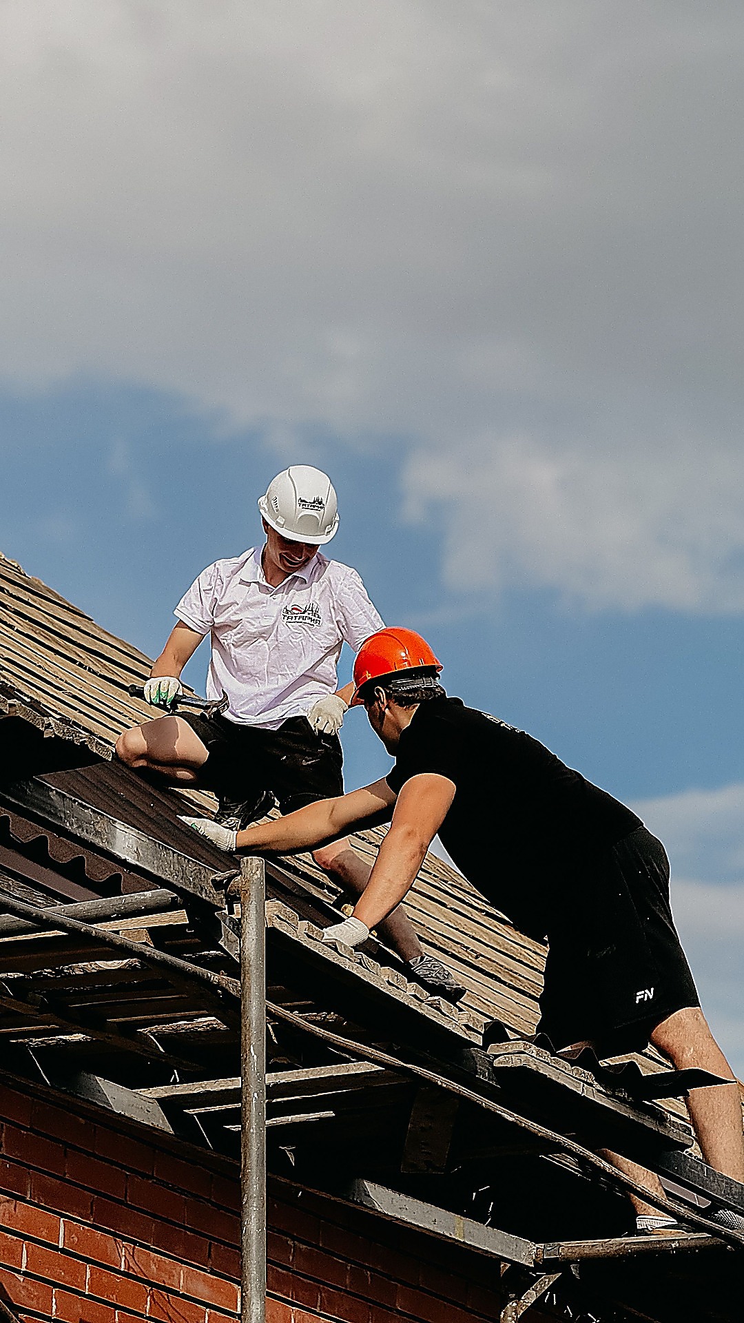 Professional crew restoring a roofline drainage system